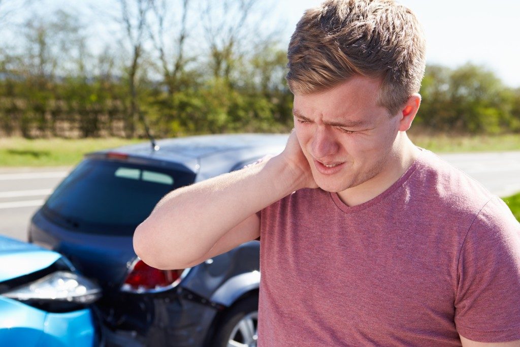 Man with his neck hurting from the accident