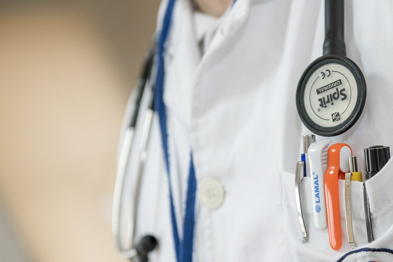 doctor wearing white lab coat with pens