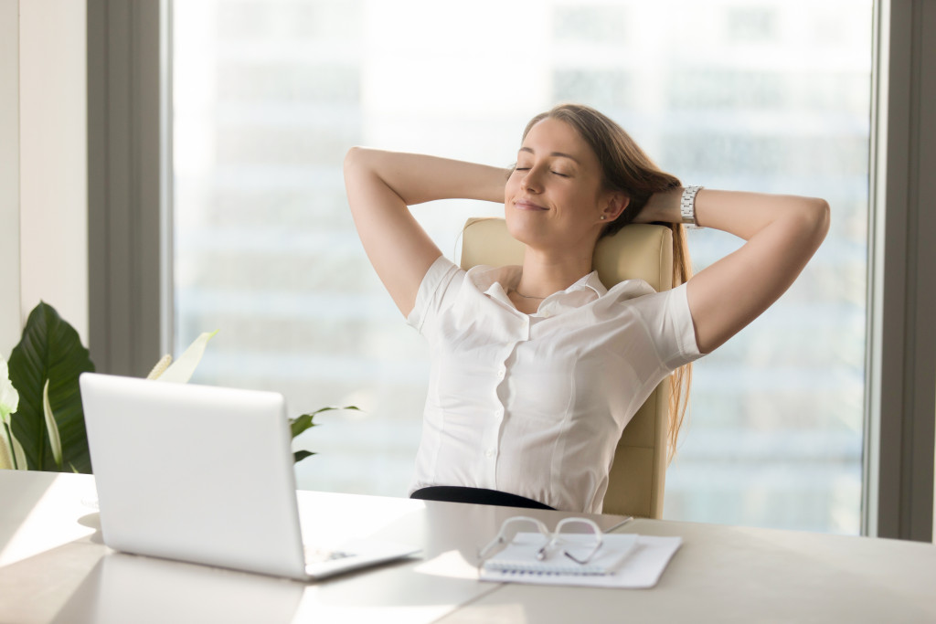 relaxed and happy female employee in her office