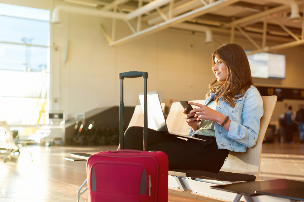 a woman in an airport with her luggage