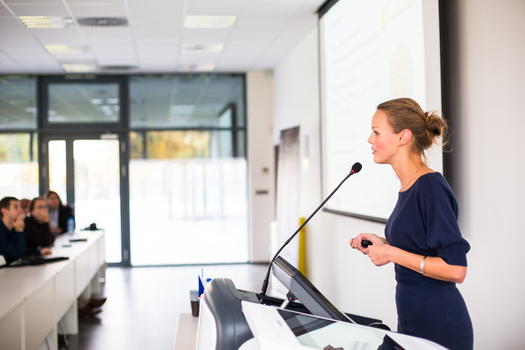 female speaker giving a presentation in meeting room