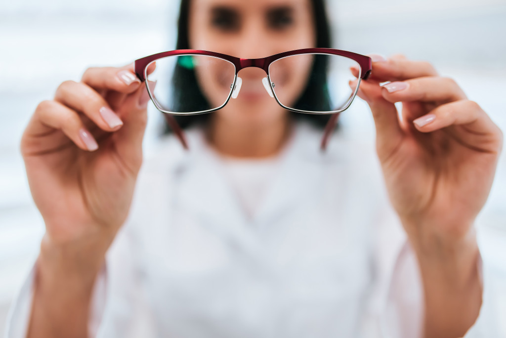 A Woman Holding Eyeglasses