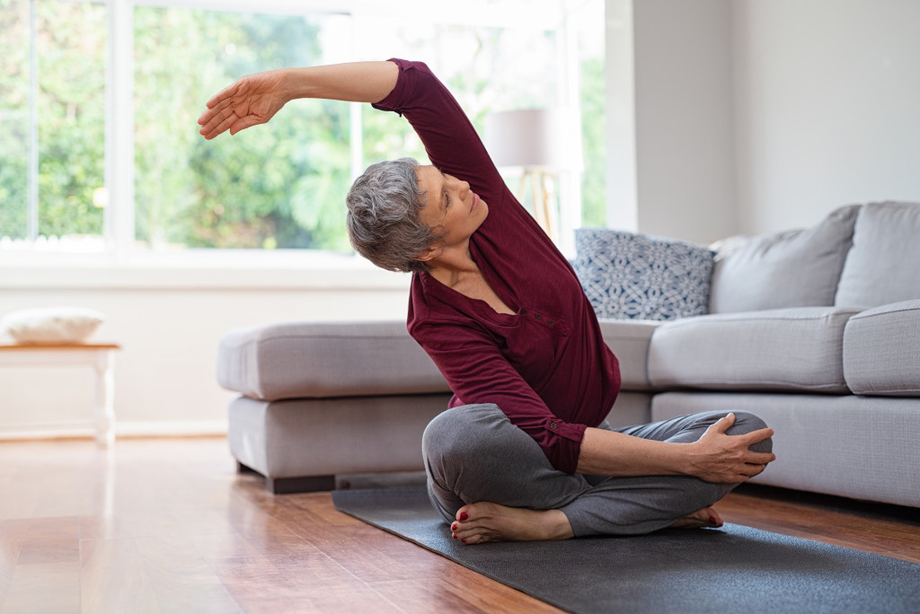 woman doing stretching in living room