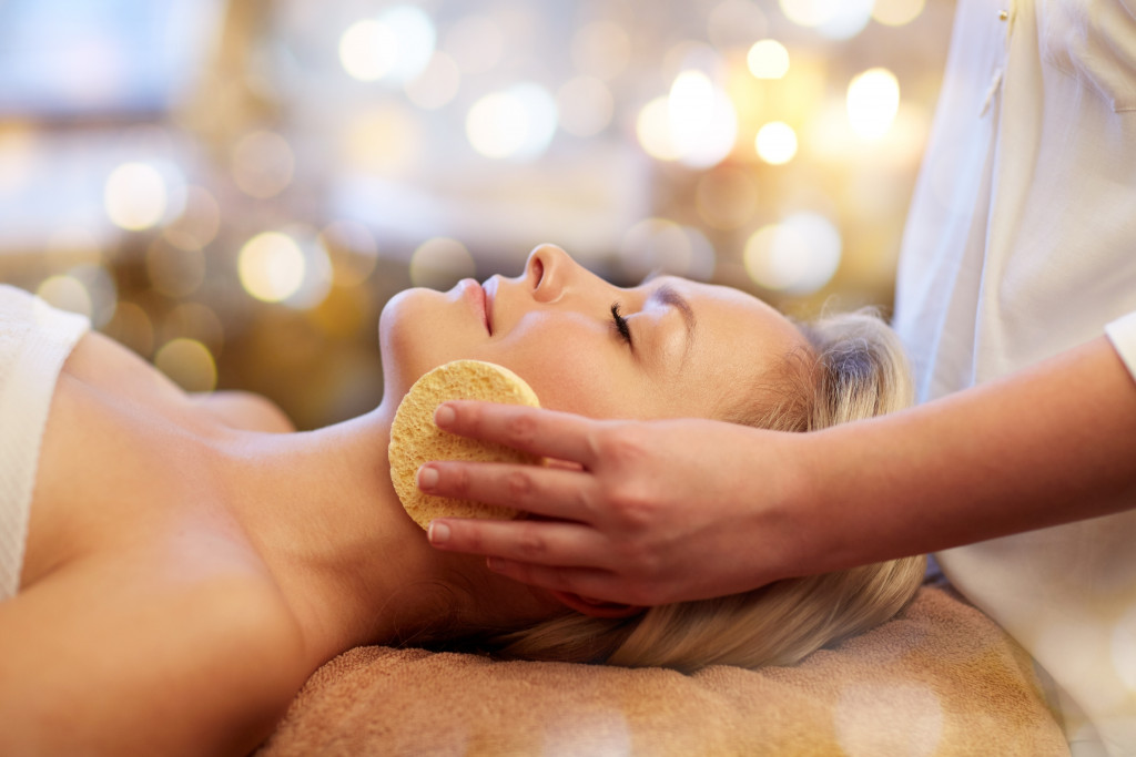 woman having a face massage concept of relaxation