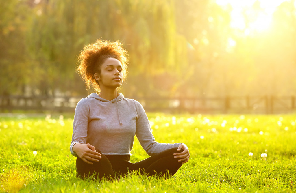 A woman meditating outdoors