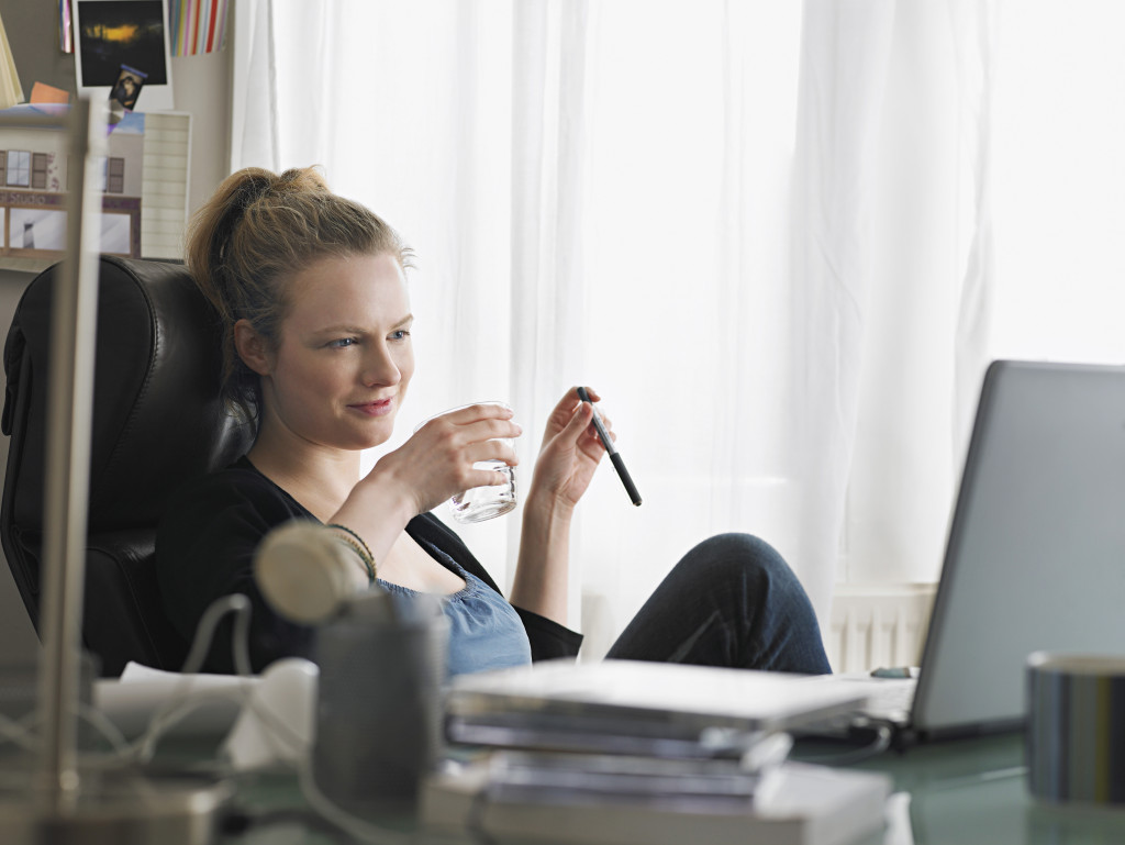 a woman drinking water in the office