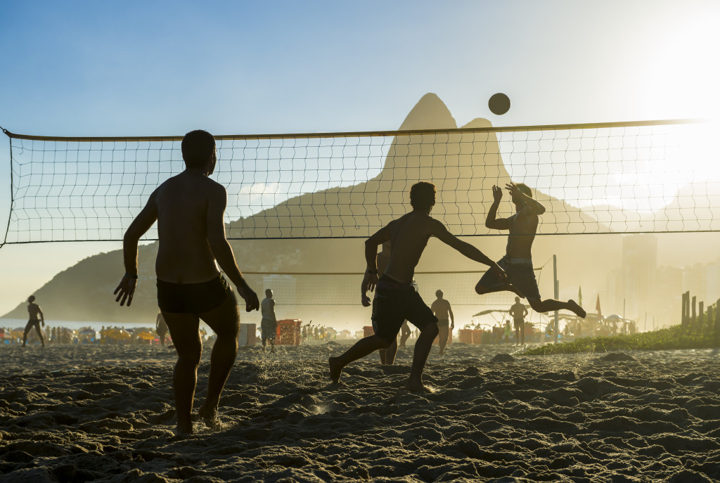 Playing beach volleyball