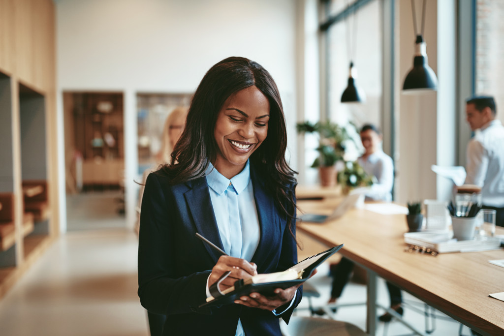 a woman taking notes smiling