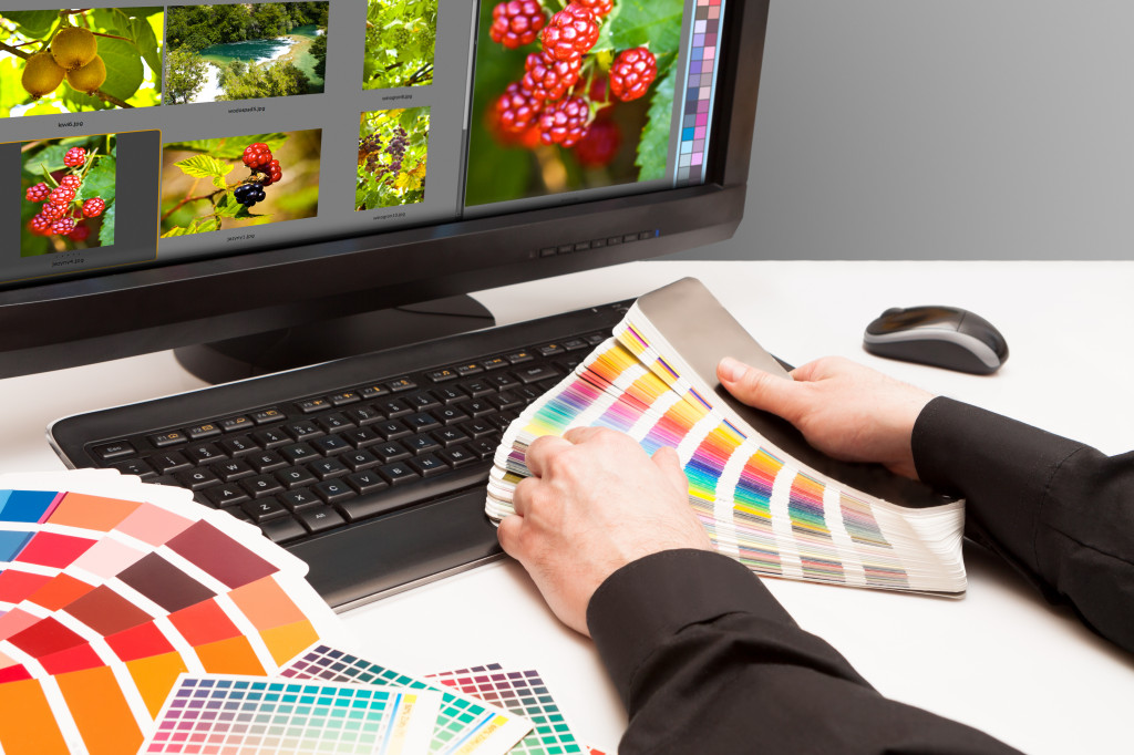 A designer looking at color swatches for photo editing