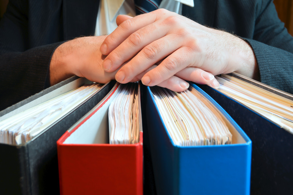 colorful binder with hands on top