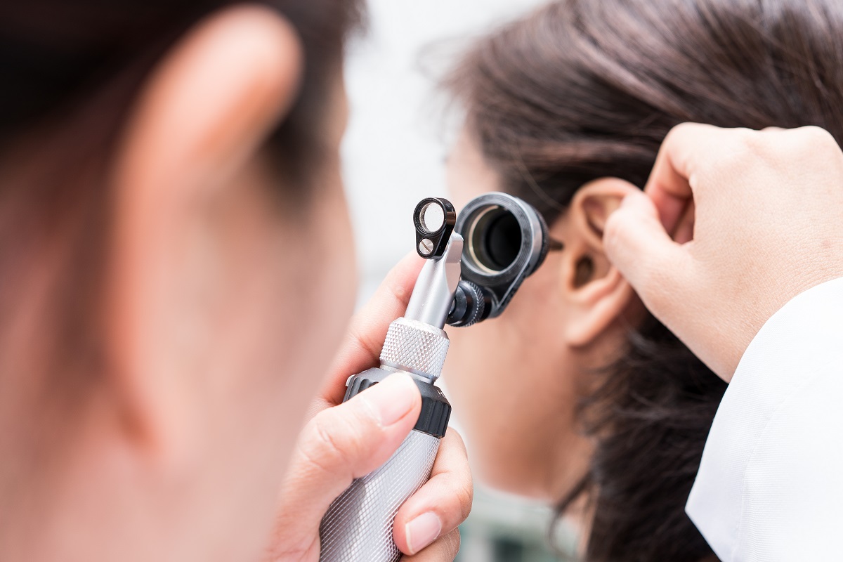 doctor examining patient's ear